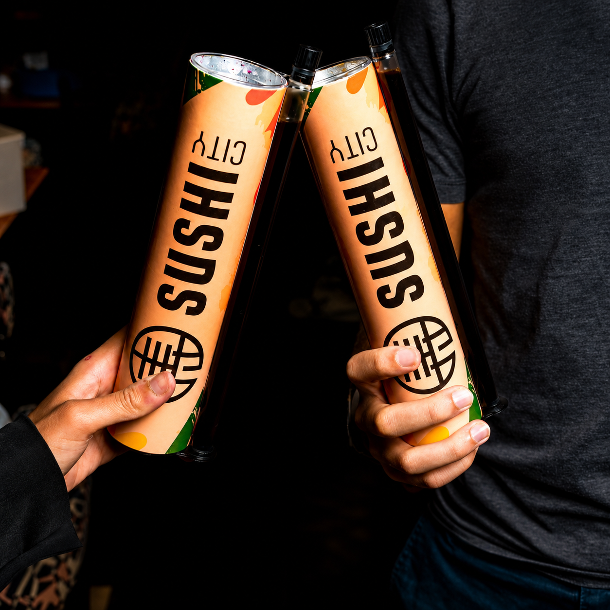 A single Sushi City branded tube with a sushi roll visible at the top